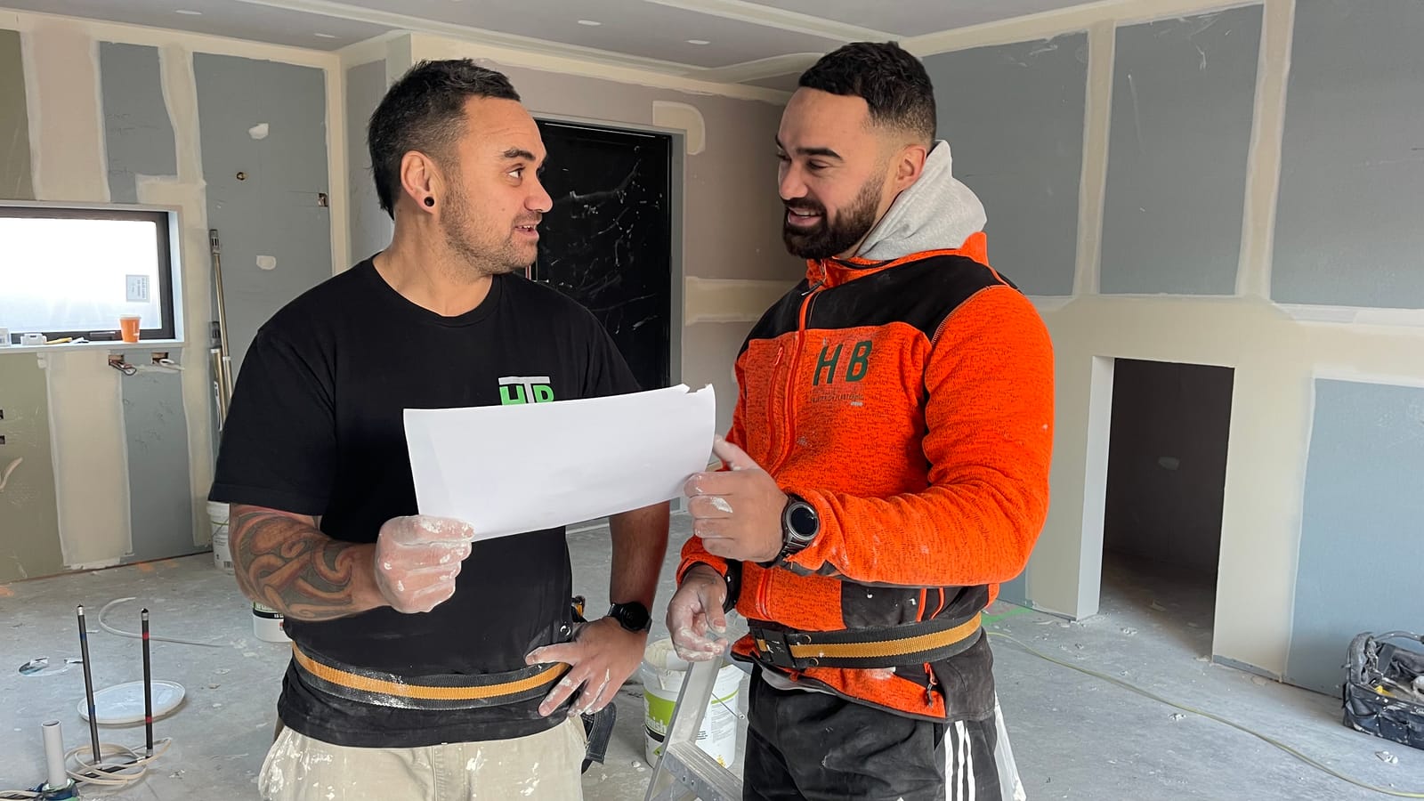 Two HB Interior Plastering workers discussing a plan